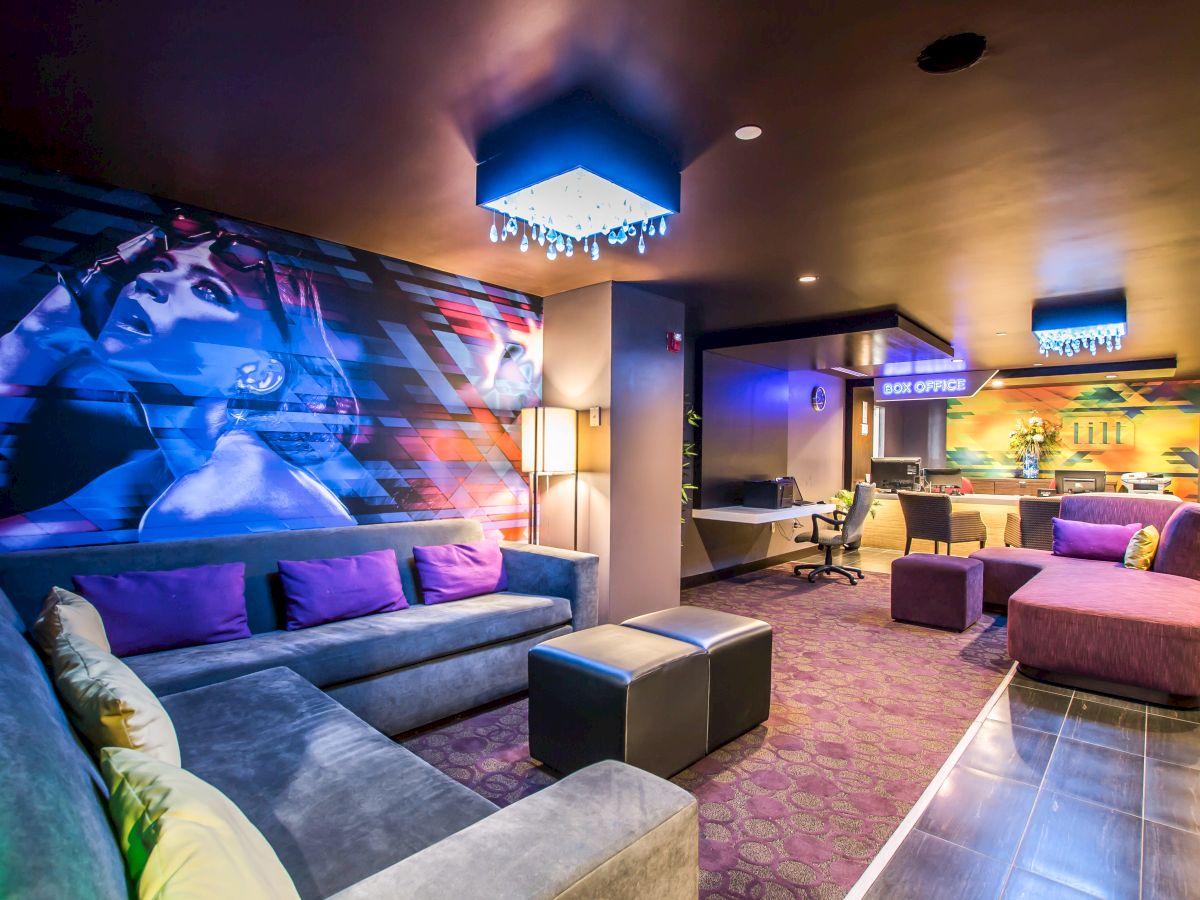 A lobby seating area with a sofa, coffee tables, and a chandelier.
